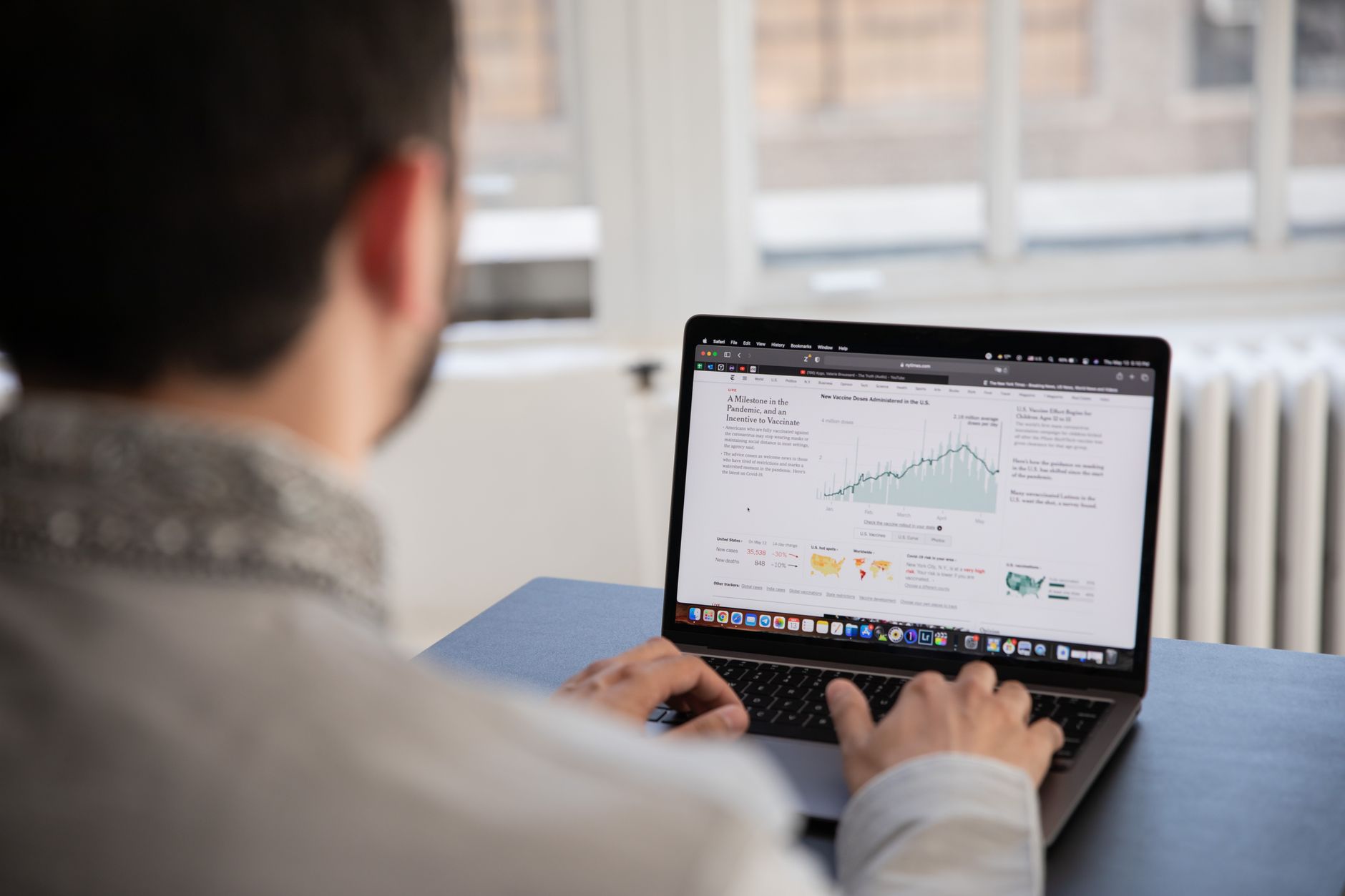 Person comparing software dashboards on a laptop screen