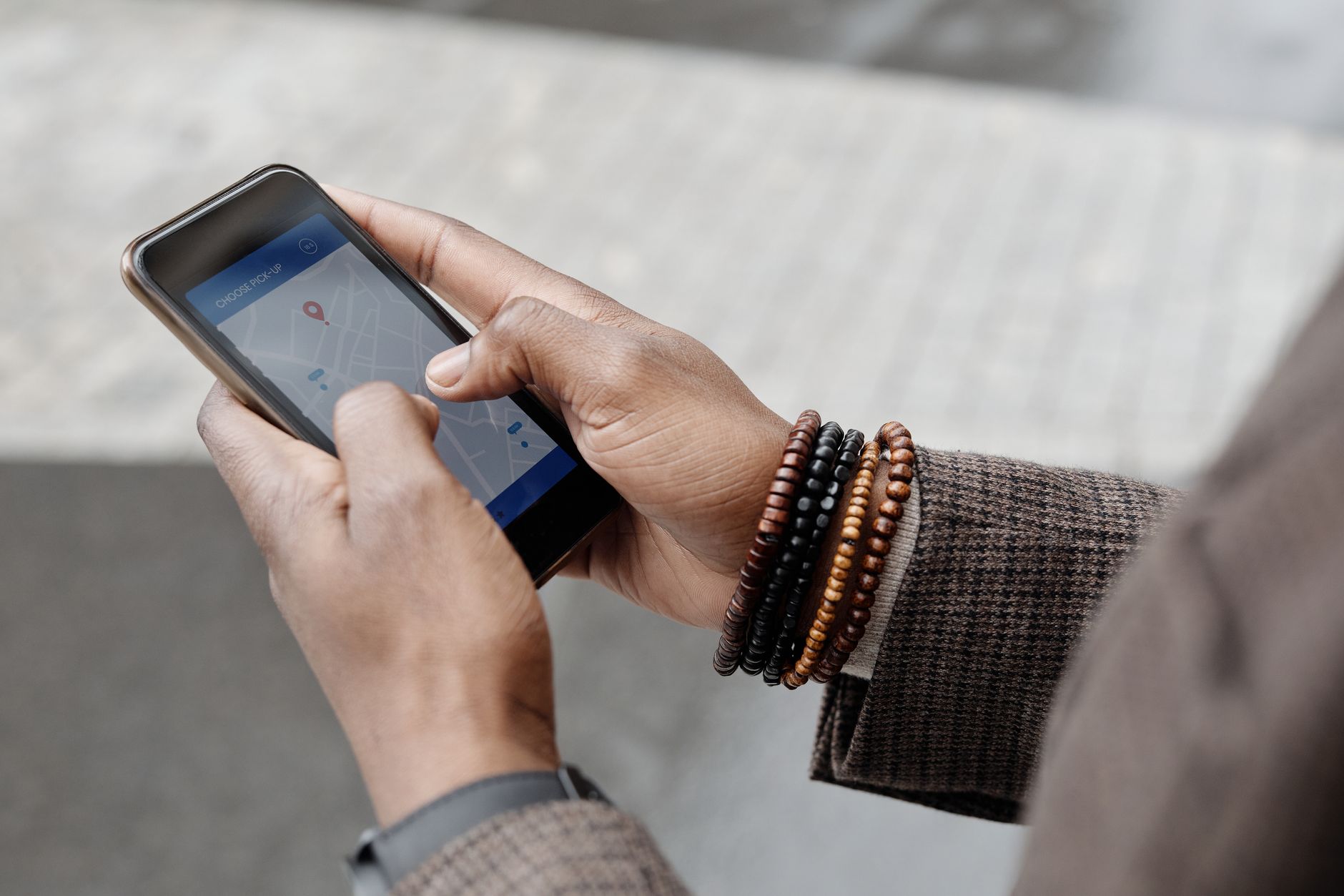 Person checking a navigation app on a smartphone while traveling