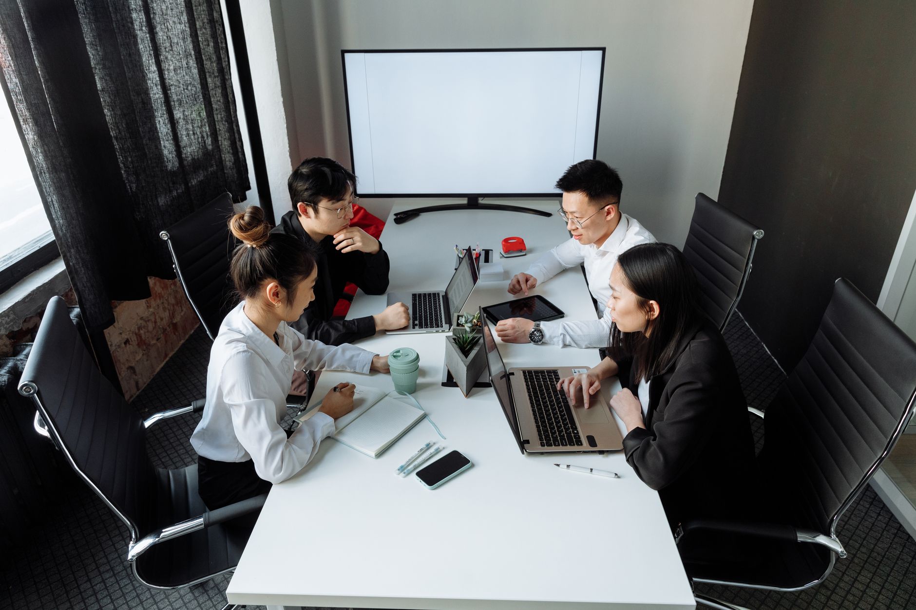 Office team in a secure video conferencing meeting on multiple screens