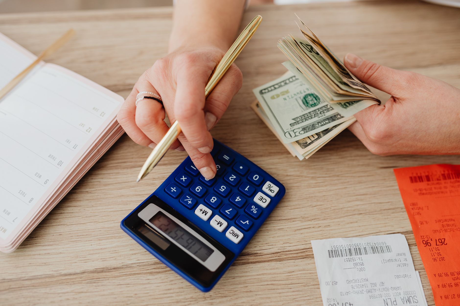 Calculator and notepad used to budget monthly software subscription costs
