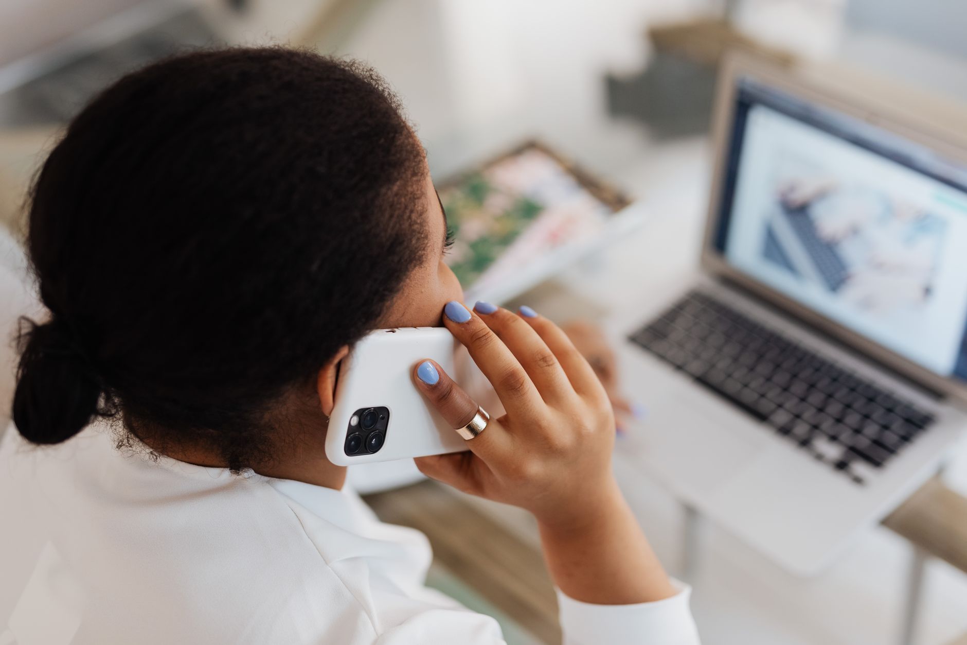 Employee taking a business call over a laptop-based VoIP connection