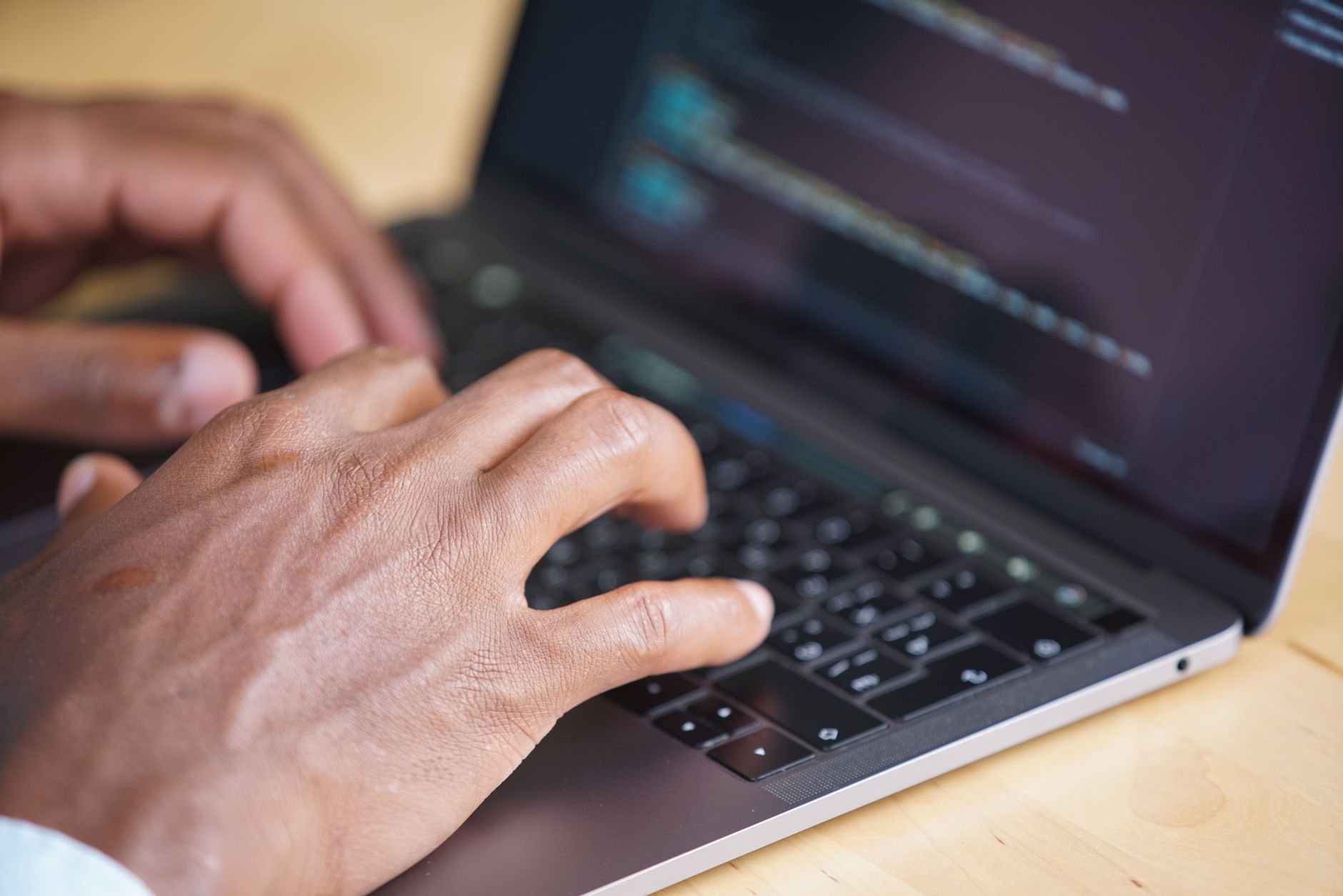 Developer typing commands into a terminal window on a laptop, illustrating what a CLI is